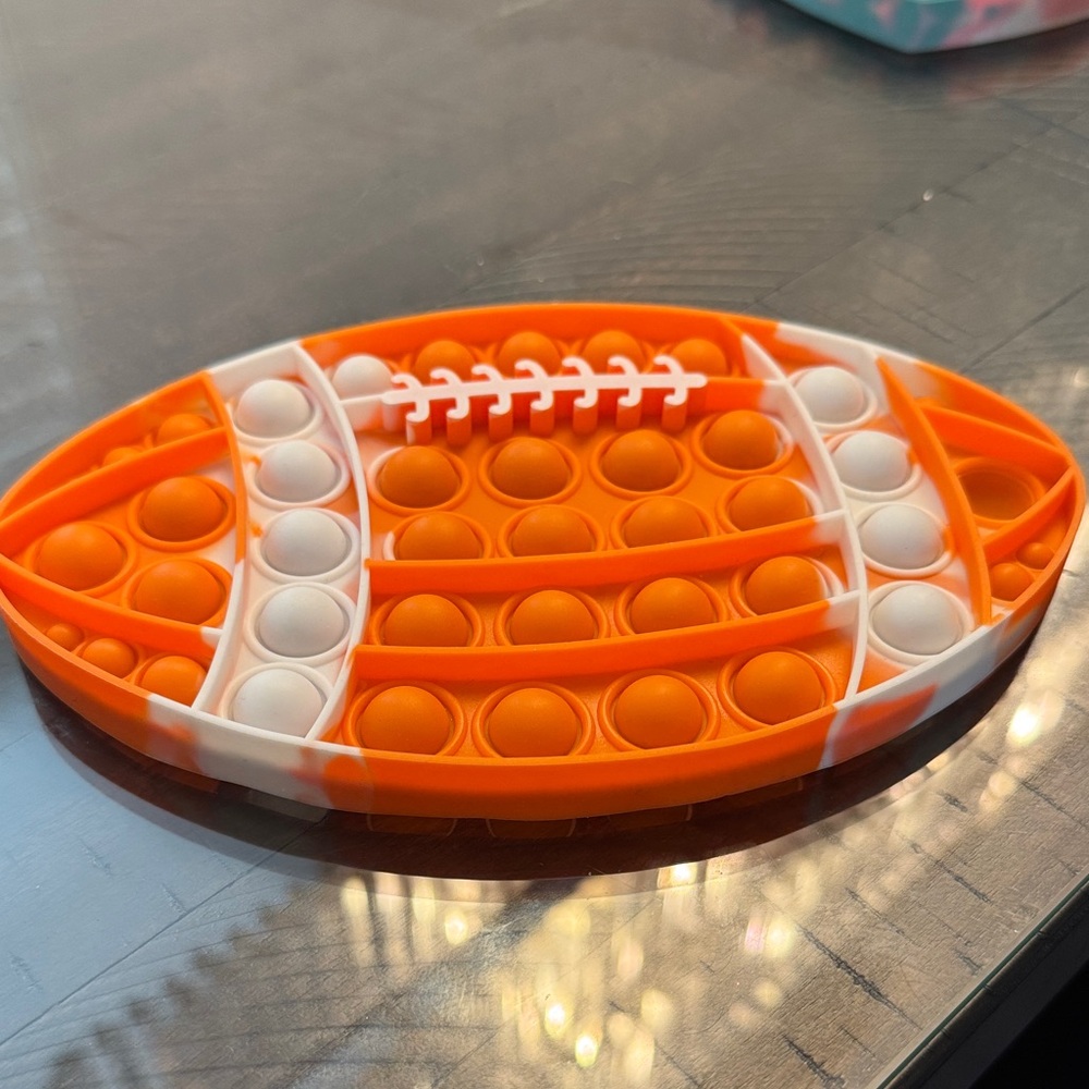 Orange and White Football Pop It Toy